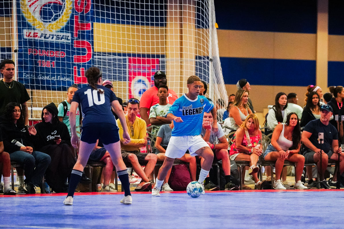 Two young adults playing futsal